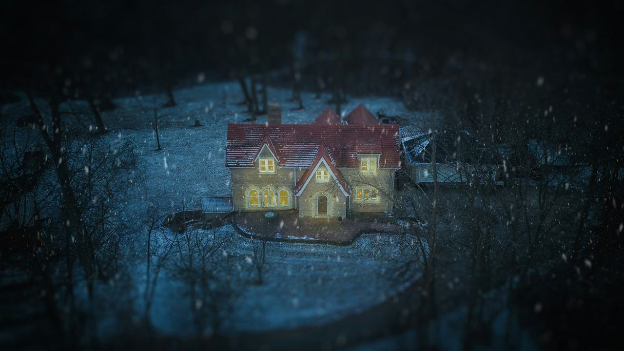 A snowy house at night with every window lit